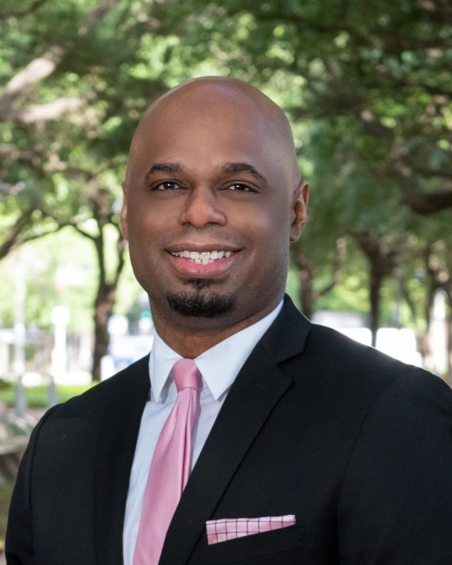 A man in a suit and tie standing outside.