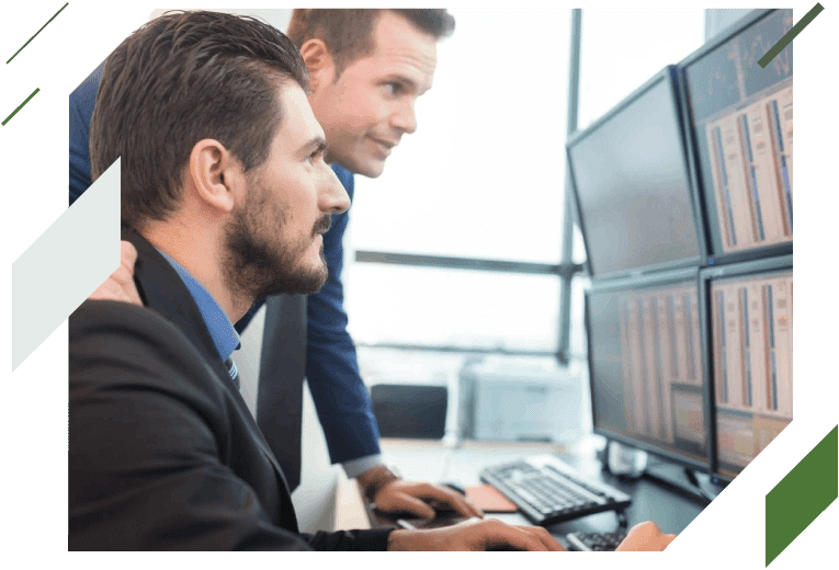 Two men in suits looking at a computer screen.