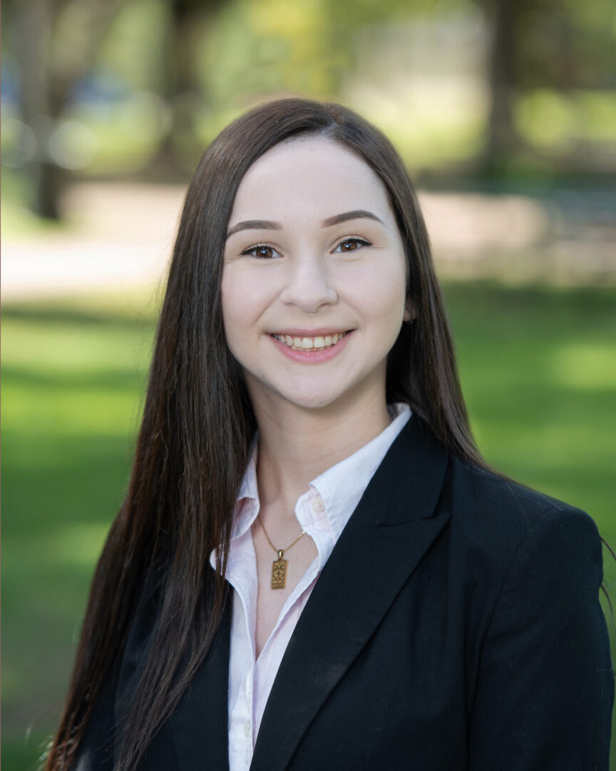 A woman in a suit and white shirt